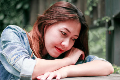 Portrait of teenage girl sitting outdoors