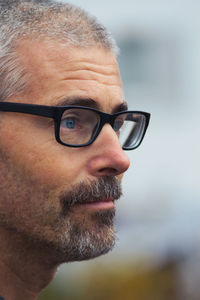 Close-up portrait of man wearing eyeglasses