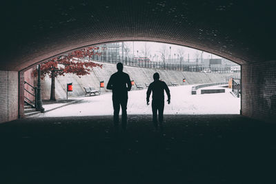 Silhouette of people walking in snow