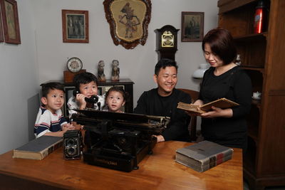 Portrait of woman using mobile phone at home