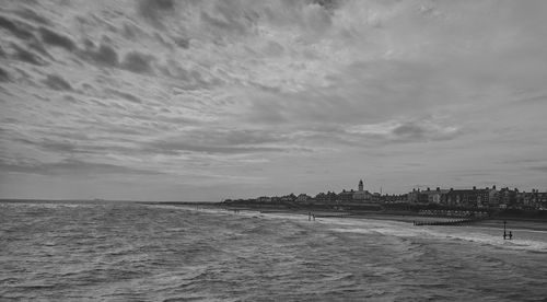 Scenic view of calm sea against cloudy sky