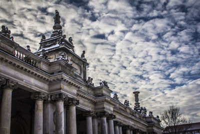 Low angle view of historical building against cloudy sky