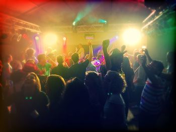 Rear view of people enjoying music concert