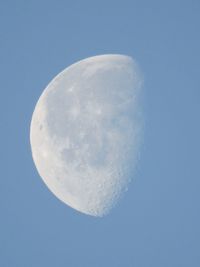 Low angle view of moon against blue sky