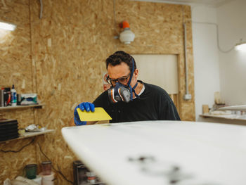 Man holding eyeglasses on table