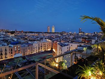 High angle view of illuminated city buildings at night