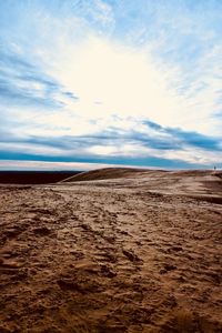 Surface level of sand on beach against sky