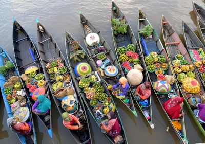 High angle view of vendors selling fruits on boats in river