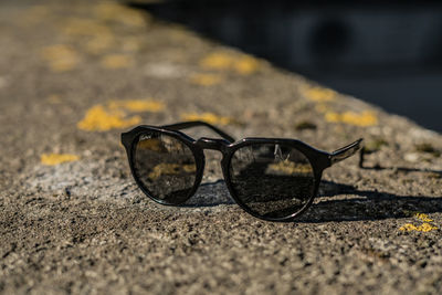 Close-up of sunglasses on road