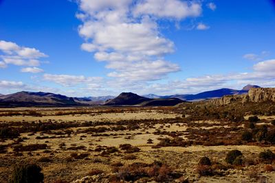 Scenic view of landscape and mountain range against sky