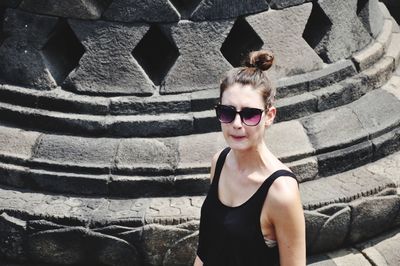 Portrait of young woman wearing sunglasses outdoors