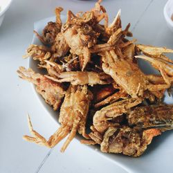 Close-up of fried crabs served on table