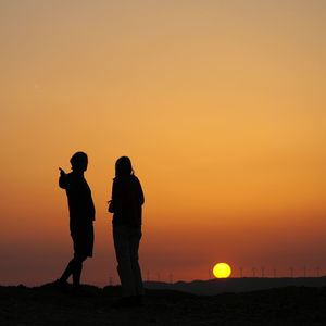 Silhouette of people at sunset