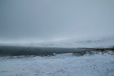 Scenic view of snow covered mountains against sky