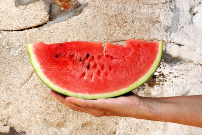 Close-up of hand holding strawberry