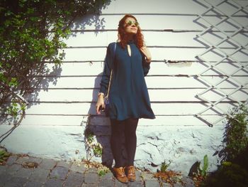Portrait of young woman standing on floor
