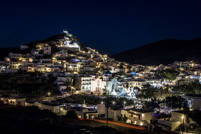 Illuminated chora in cyclades ios greek island at night, greece