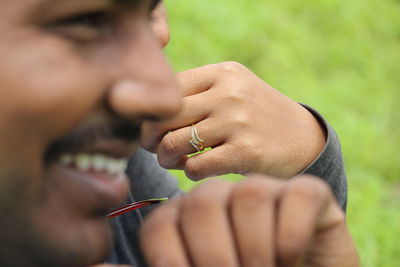 Close-up of couple sitting outdoors