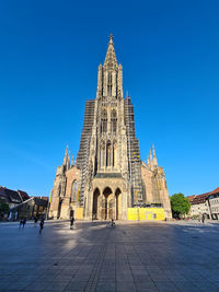 Low angle view of historic building against clear blue sky