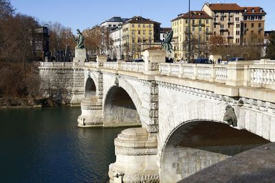 Arch bridge over river in city