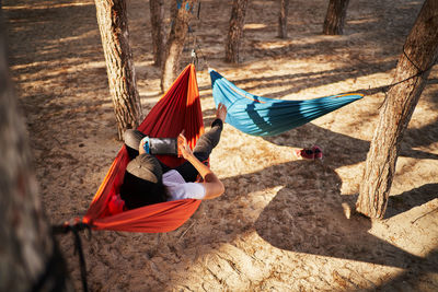 Man lying on hammock at beach