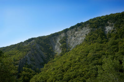Scenic view of mountains against clear blue sky
