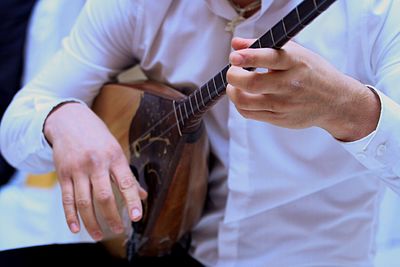 Cropped image of woman holding tattoo