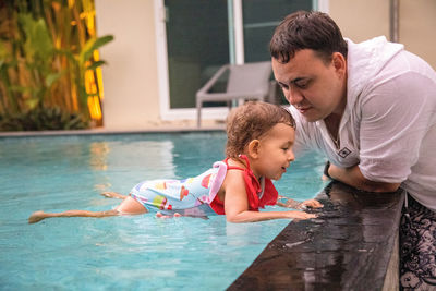 Father and son on swimming pool