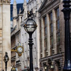 Street light against buildings in city