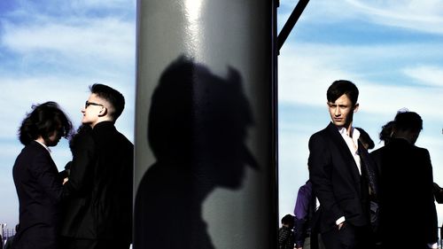 People standing against sky