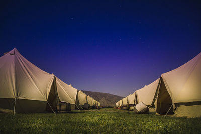 Tent on field against clear sky at night