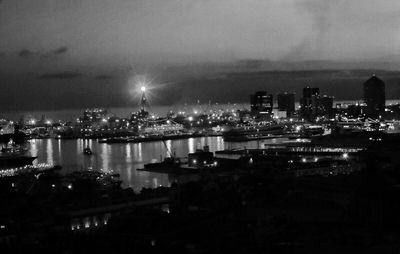 Illuminated cityscape against sky at night