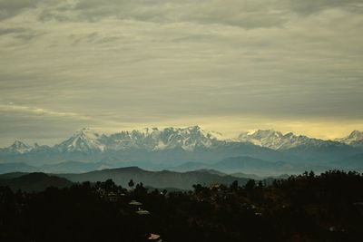 Scenic view of silhouette mountains against sky during sunset