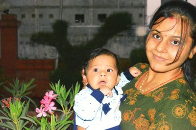 Portrait of young woman with baby boy