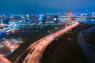 High angle view of light trails on highway at night