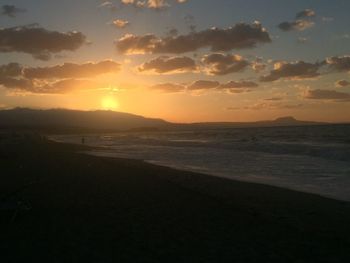 Scenic view of beach against sky during sunset