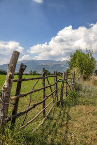 Fence on field against sky