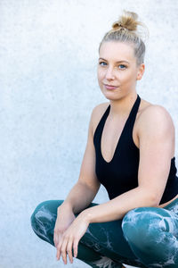 Portrait of young woman exercising in gym