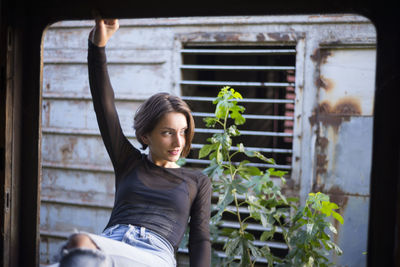 Young woman at window of abandoned train 