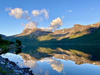 Scenic view of lake and mountains against sky