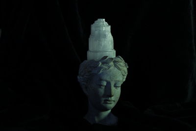 Close-up of statue against black background