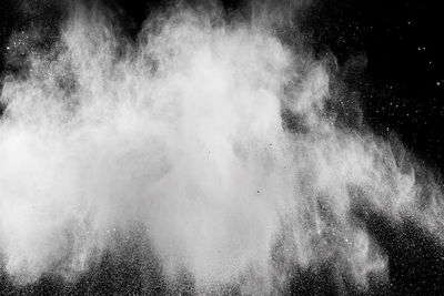Close-up of exploding dust against black background