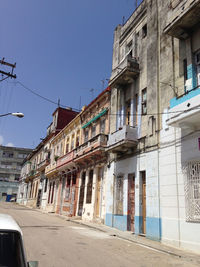 Street by buildings against clear sky