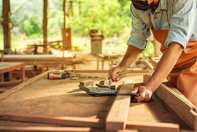 Man working on wooden table