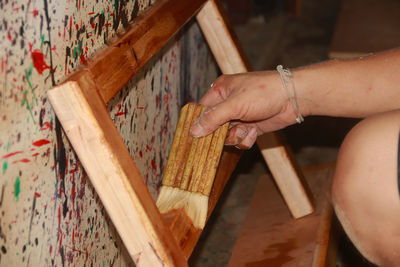 High angle view of woman hand on table