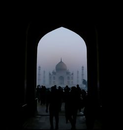 Group of people walking in front of historical building