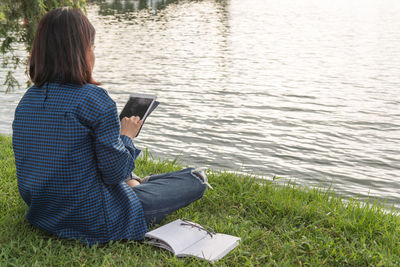 Rear view of woman standing in lake