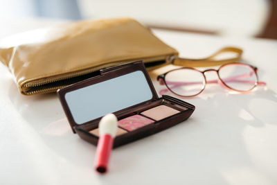 Women's handbag cosmetic, glasses and palette with cosmetics