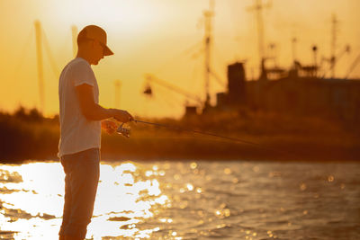 Rear view of man standing in sea