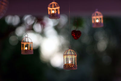 Close-up of illuminated lanterns hanging at night